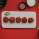 Platter of five bright-red mac and cheese balls on a white plate between bags of Cheetos, reprinted with permission from PepsiCo/Cheetos/Ketchum